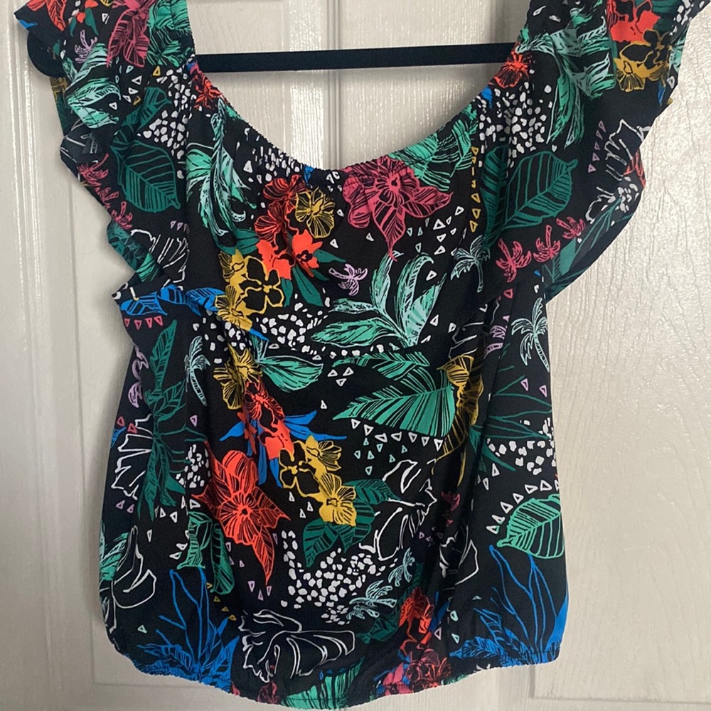 Black shirt with tropical flowers off the shoulders